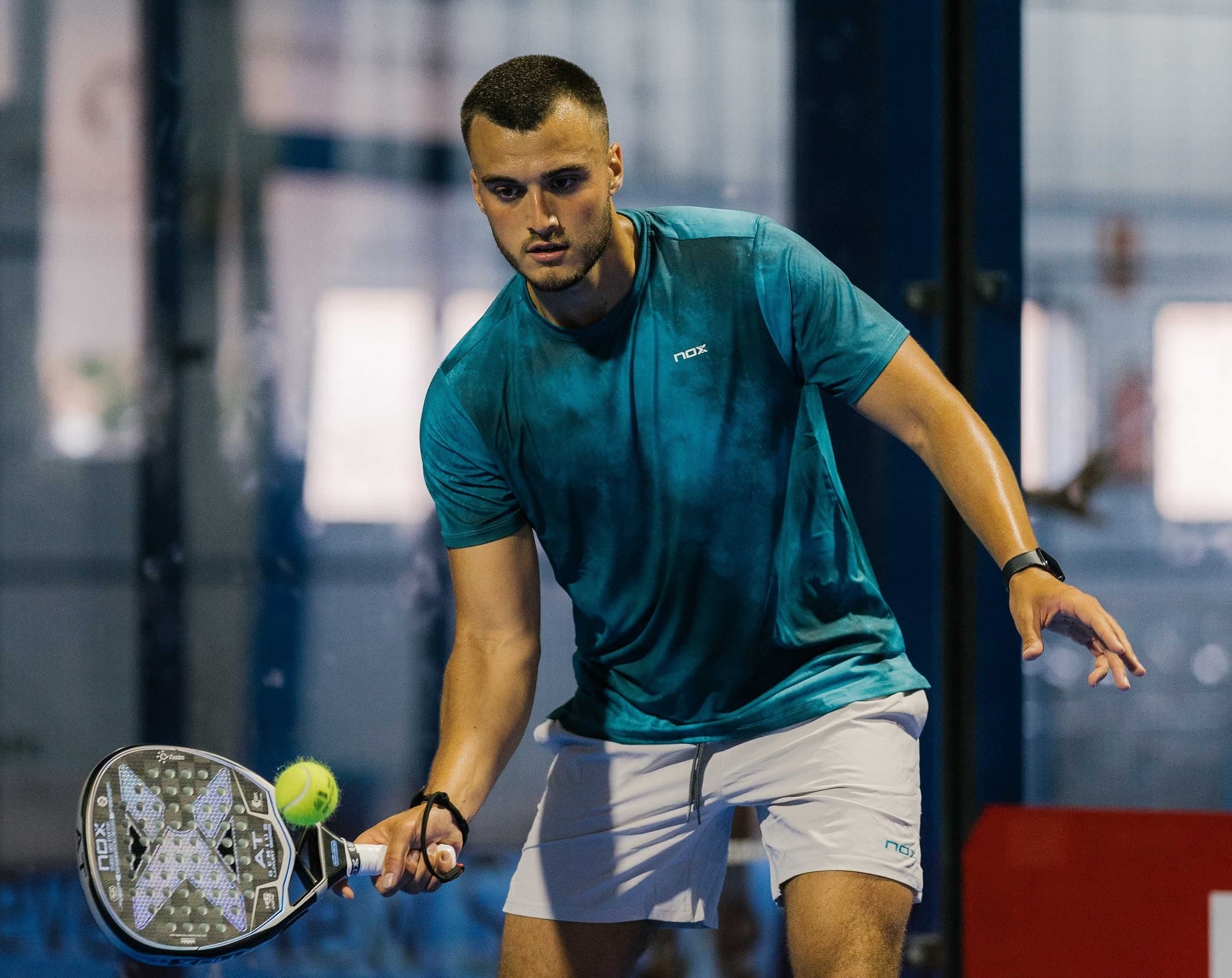 Louie Harris preparing to play a forehand during a padel match