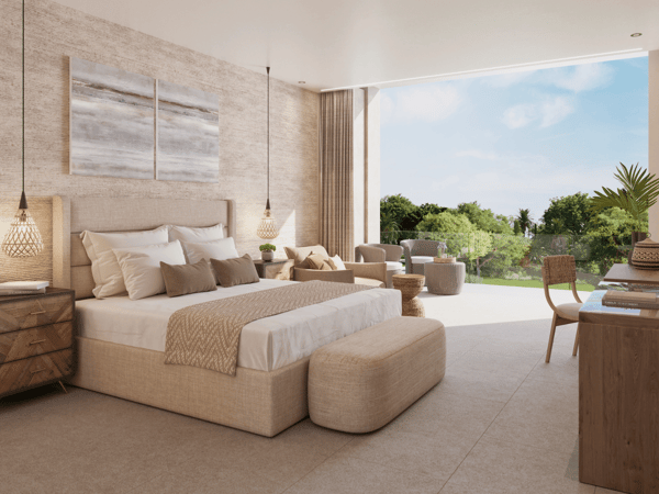 Bright, modern resort bedroom with terrace seating and lush garden view.