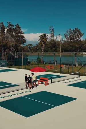 Wide aerial view of the branded outdoor pickleball courts beside Titreyengöl at Megasaray Resort Side.