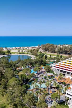 Aerial view across Megasaray Resort Side, Titreyengol and the sandy beach.