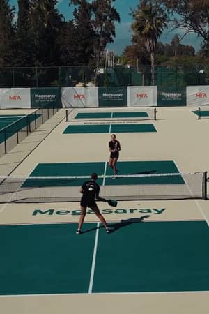 Elevated view of two players on the branded outdoor pickleball courts at Megasaray Resort Side.