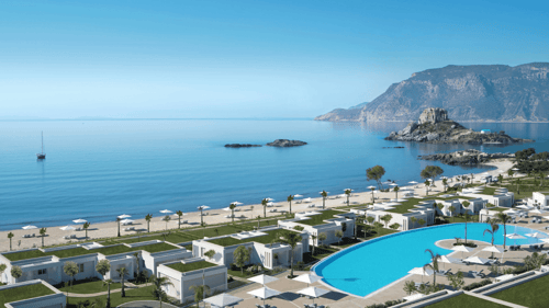 Luxury beachfront resort with pool, white villas and umbrellas beside calm Aegean sea and rocky islet.