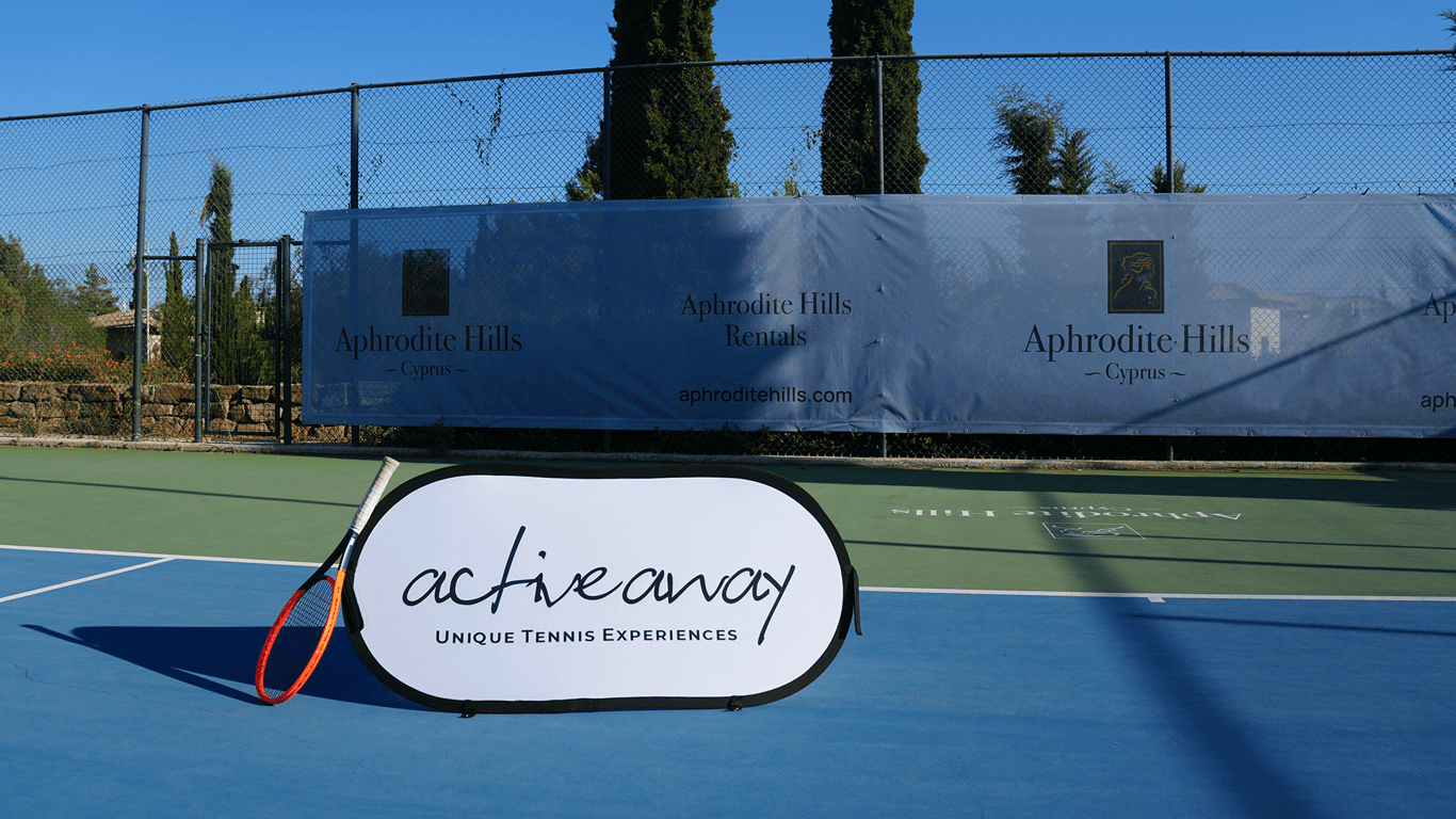 Active Away sign and tennis racket on a sunny court at Aphrodite Hills, Cyprus.