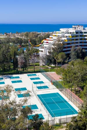 Aerial view of the pickleball courts, hotel and Mediterranean coast at Megasaray Resort Side.