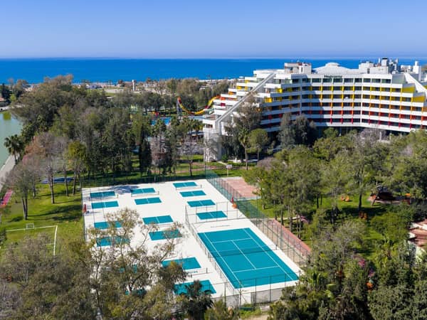 Aerial view of the pickleball courts, hotel and Mediterranean coast at Megasaray Resort Side.