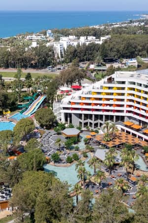 Aerial view of Megasaray Resort Side, its pools and the Mediterranean coast.