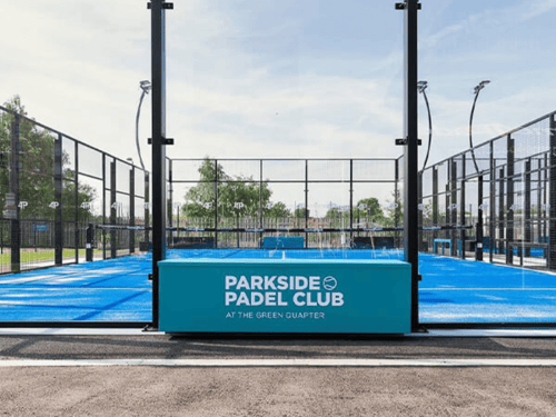 Blue padel court with glass walls at Parkside Padel Club.