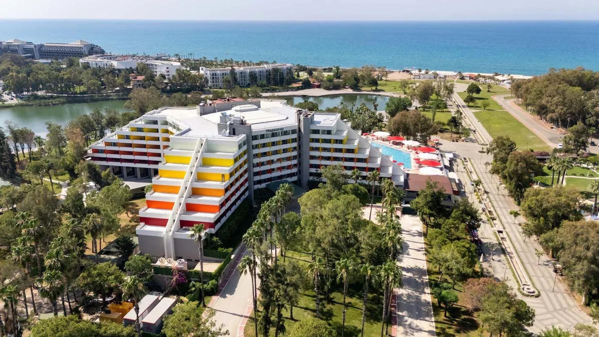 Aerial view of Megasaray Resort Side with the hotel, lagoon and Mediterranean coast beyond.