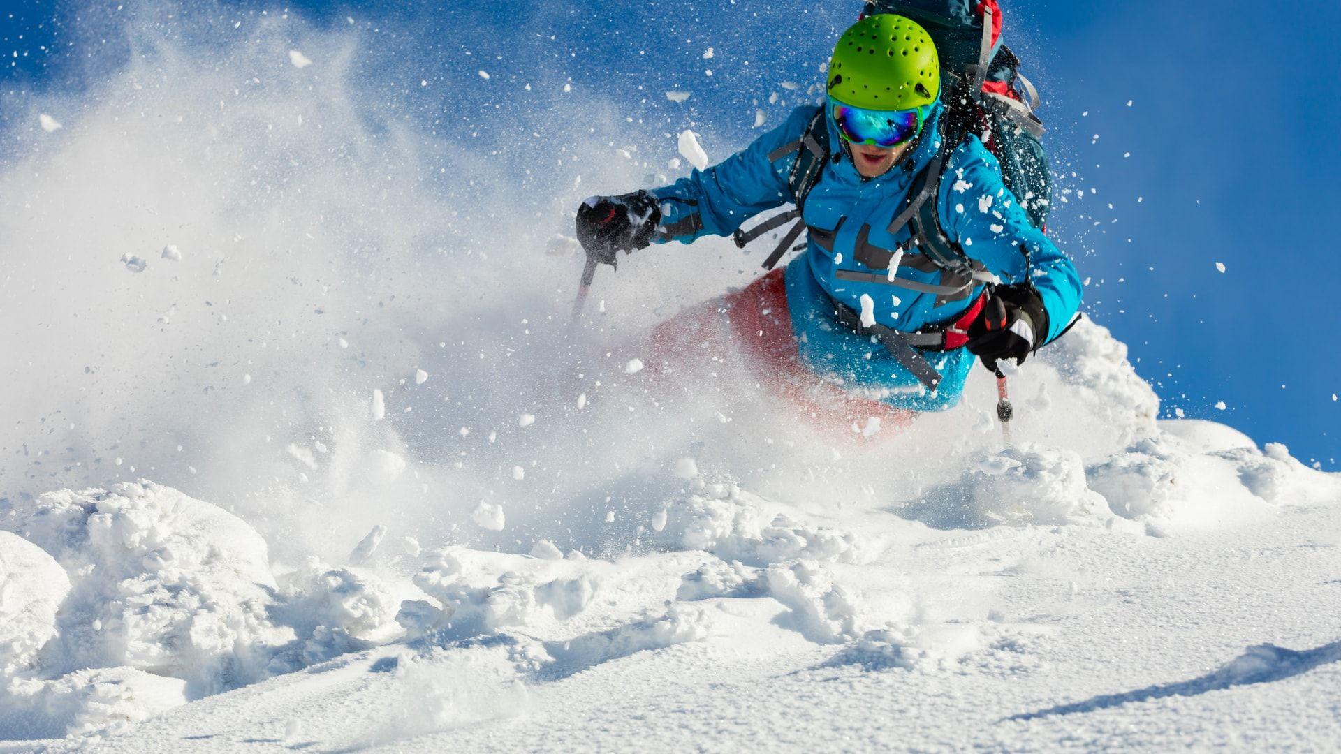 Skier carving through powder on the slopes above Alagna