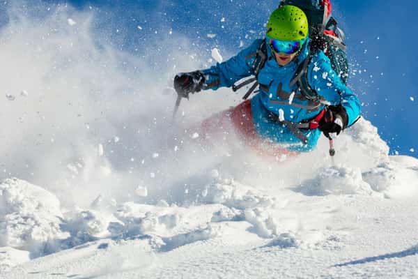 Skier carving through powder on the slopes above Alagna