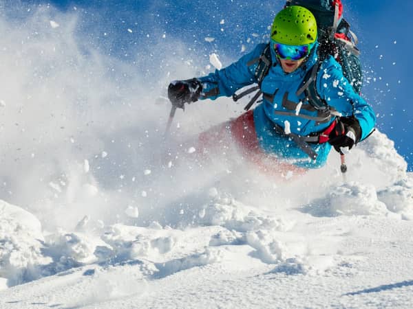 Skier carving through powder on the slopes above Alagna