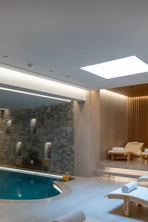 Indoor pool and relaxation loungers at the Royal Wellness Club, Nana Golden Beach.