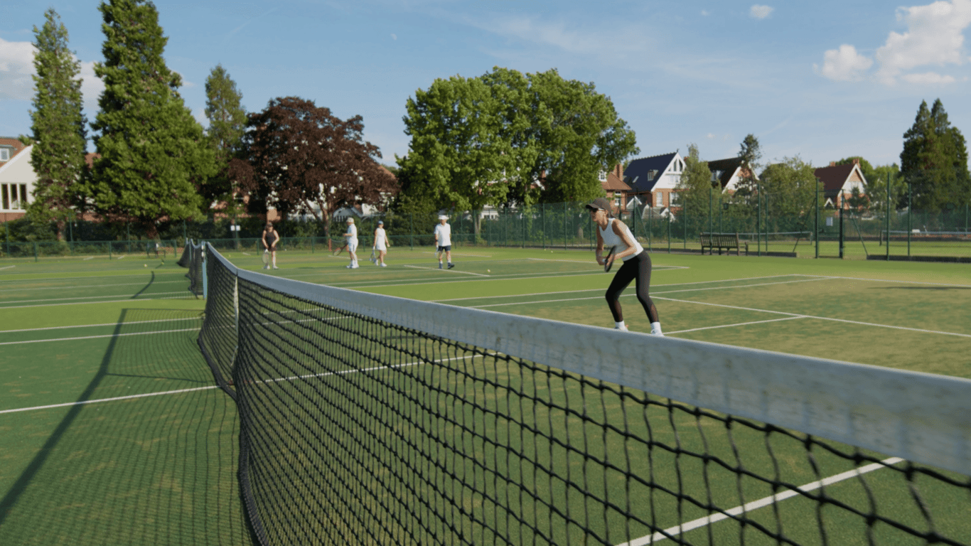 Players doing tennis drills on outdoor courts at Lensbury; a woman prepares to return near the net.