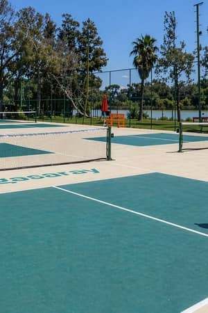 Two players rally on the branded outdoor pickleball courts at Megasaray Resort Side beside Titreyengöl.