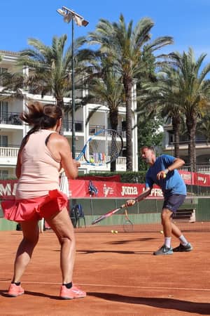 Guests taking part in a live tennis coaching drill at Beach Club Mallorca