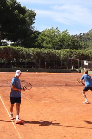 Active Away group tennis coaching session on clay courts in Mallorca