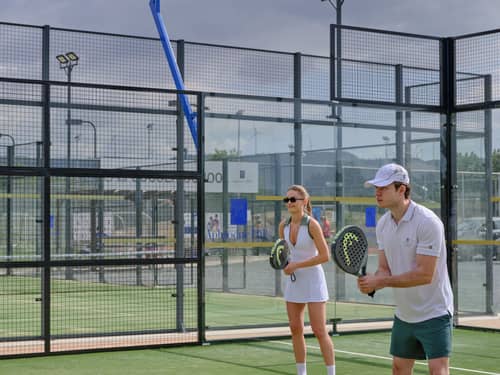 Two padel players on court at Aphrodite Hills Racket Club