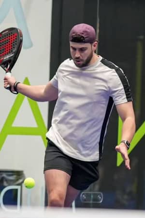 Padel player on a branded court at Advantage Padel Mudeford