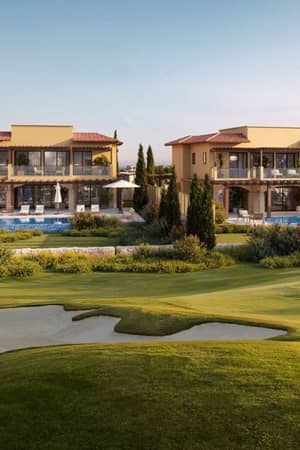 Two villas at Aphrodite Hills Resort, Cyprus, with modern design, private pools, and golf course views.