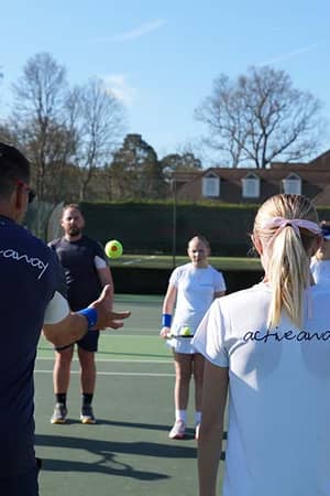 Junior tennis camp at Royal Russell School with Active Away coaches instructing children on tennis techniques on an outdoor court.