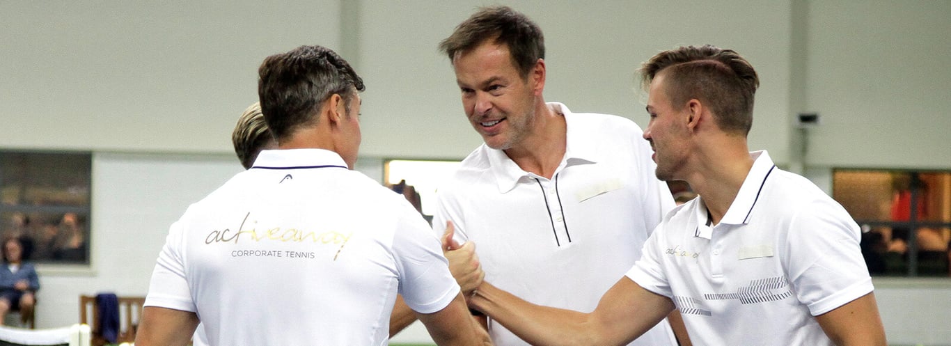 Peter Jones and Active Away team members in white polos, celebrating a pitch success on Dragons' Den.