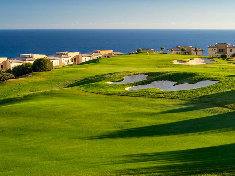 Villas at Aphrodite Hills Resort in Cyprus overlooking a golf course and the Mediterranean Sea.