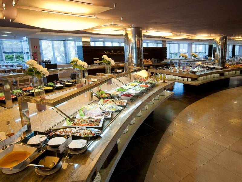 Beach Club buffet area with a variety of dishes, modern decor, and warm lighting.