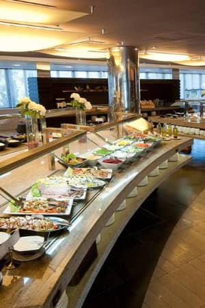 Beach Club buffet area with a variety of dishes, modern decor, and warm lighting.