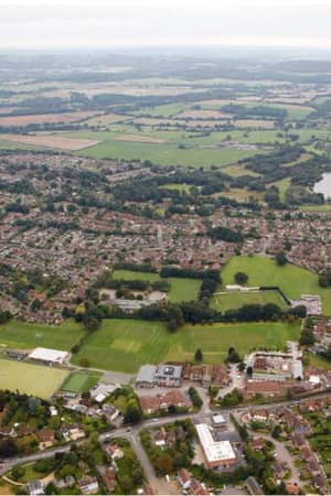 Aerial view of Churcher's College in Petersfield, featuring sports fields, tennis courts, and the surrounding residential areas.
