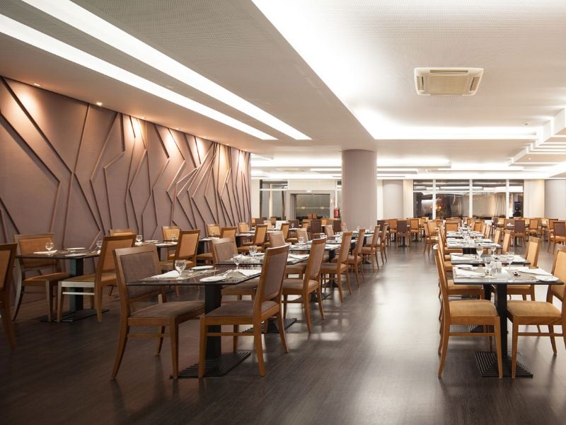 Spacious buffet dining area at Dom Pedro Gallery with modern decor and wooden furniture.