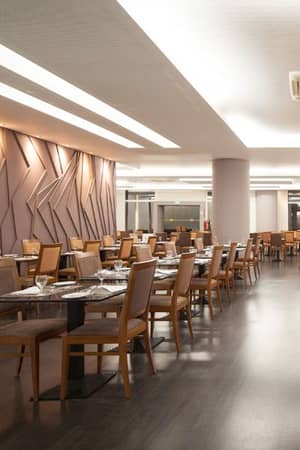 Spacious buffet dining area at Dom Pedro Gallery with modern decor and wooden furniture.