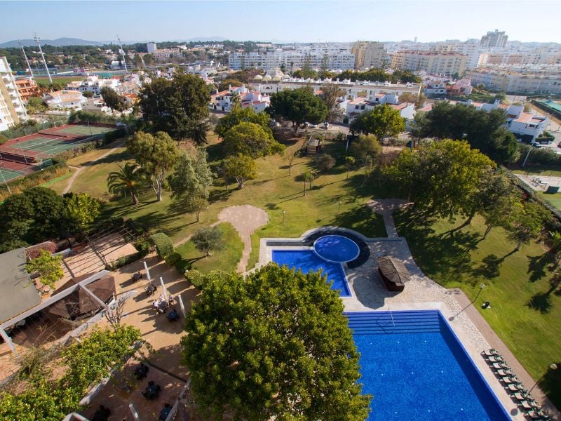 Aerial view of Dom Pedro Gallery pool with surrounding gardens and urban backdrop.