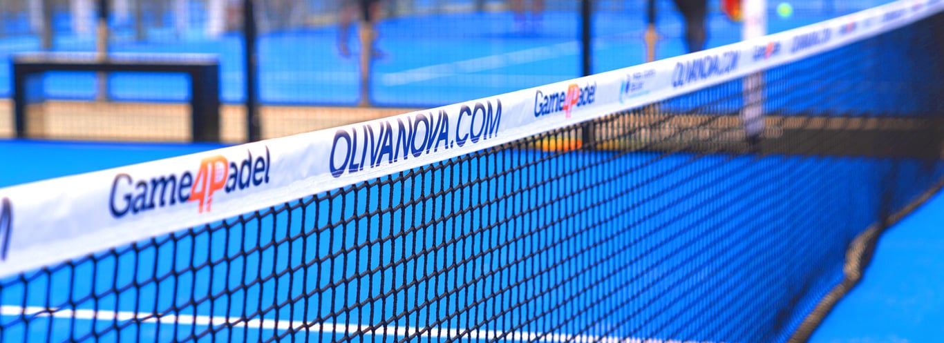 Close-up of a padel court net with Game4Padel and Oliva Nova branding against a blue court background.