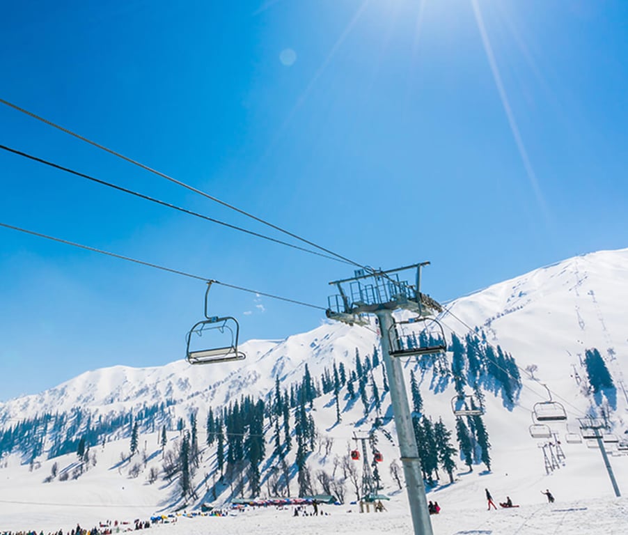 Ski lift at Hotel Monterosa with snow-covered mountains in the background under a clear blue sky.