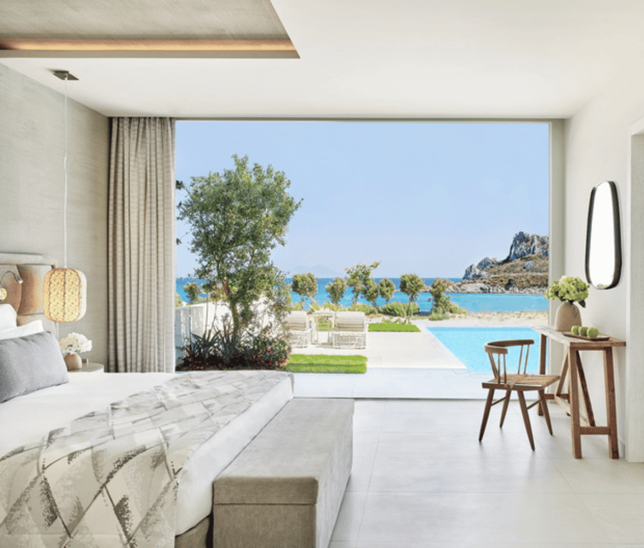 Deluxe One Bedroom Bungalow Suite at Ikos Aria with private pool, sea view, and modern interior featuring a king-sized bed and large window.