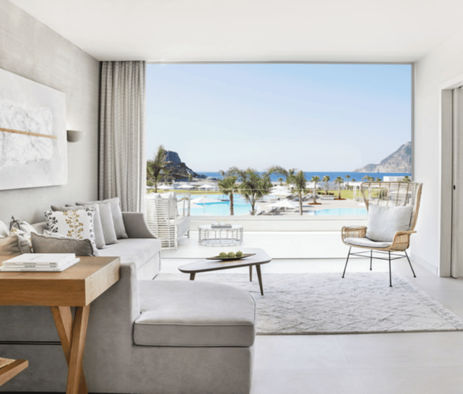 Modern deluxe one-bedroom bungalow suite at Ikos Aria with sea view, featuring contemporary decor and beachfront outlook.