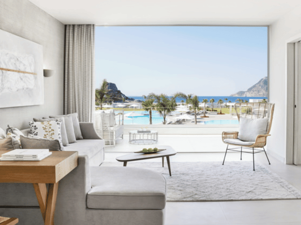 Modern deluxe one-bedroom bungalow suite at Ikos Aria with sea view, featuring contemporary decor and beachfront outlook.