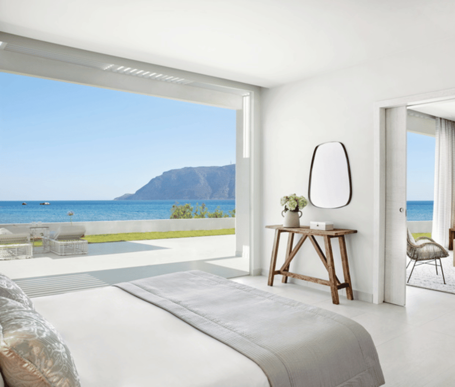 Ikos Aria Deluxe Two Bedroom Bungalow Suite Beach Front with ocean view, elegant furnishings, and private outdoor seating.