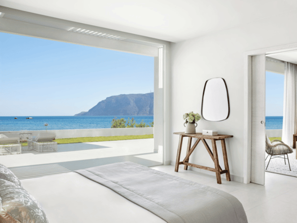 Ikos Aria Deluxe Two Bedroom Bungalow Suite Beach Front with ocean view, elegant furnishings, and private outdoor seating.
