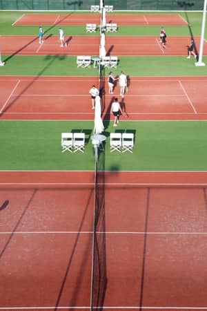 Aerial view of tennis courts at Ikos Aria resort with players on the courts enjoying tennis matches.
