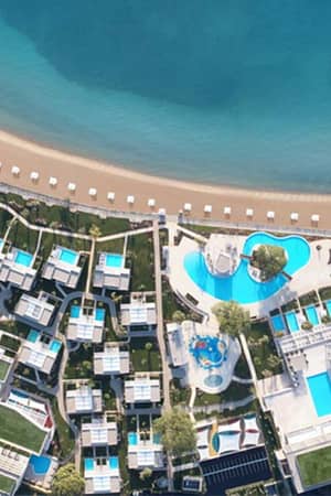 Aerial view of Ikos Dassia resort, showcasing swimming pools, gardens, and Dassia Beach on the Ionian Sea.