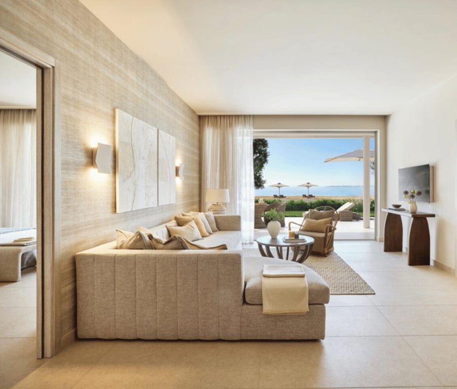 Ikos Odisia Deluxe Two Bedroom Bungalow Suite with private garden, sea view, modern living area, and elegant decor.