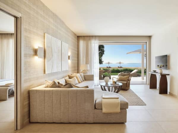Ikos Odisia Deluxe Two Bedroom Bungalow Suite with private garden, sea view, modern living area, and elegant decor.