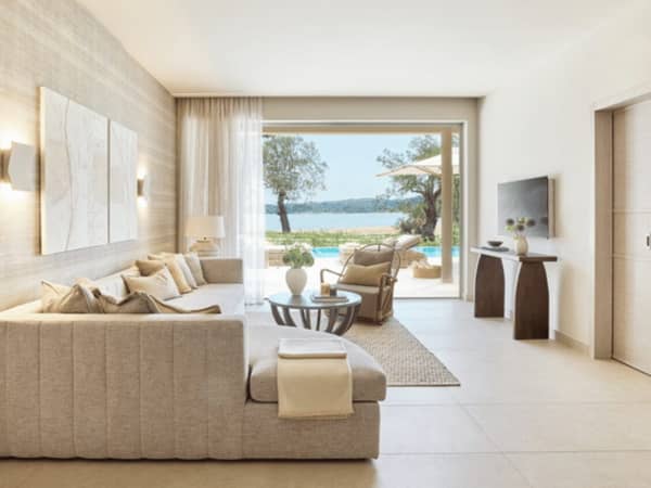 Luxurious bungalow suite at Ikos Odisia with a modern living room, private pool, and view of the sea.