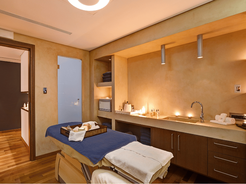 Spa treatment room at Kalimera Kriti with a massage table, fresh towels, and a calming ambiance.