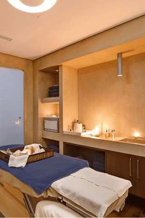 Spa treatment room at Kalimera Kriti with a massage table, fresh towels, and a calming ambiance.