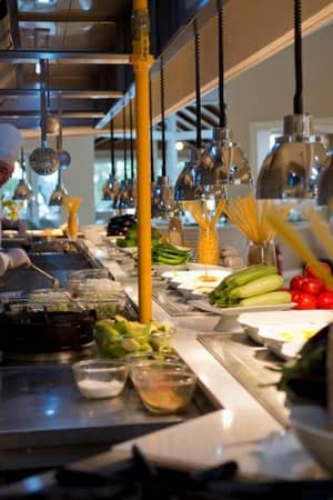Two chefs preparing meals with fresh ingredients in a modern kitchen at Liberty Lykia.