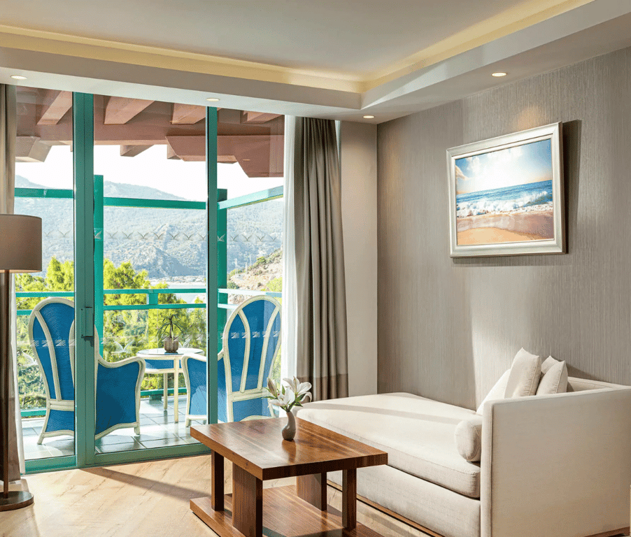 Liberty Sentido Deluxe hotel room with chaise longue and balcony overlooking the sea.