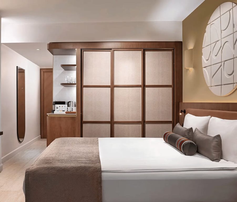 Luxurious Liberty Village FTH connected room with a double bed, sea view, and modern amenities including a coffee machine.