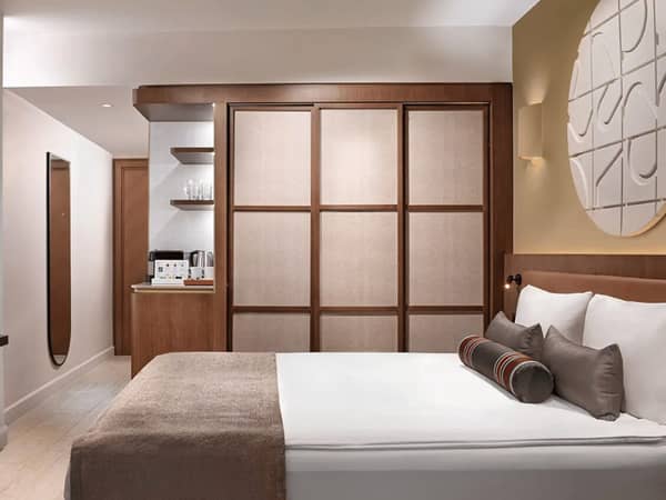 Luxurious Liberty Village FTH connected room with a double bed, sea view, and modern amenities including a coffee machine.